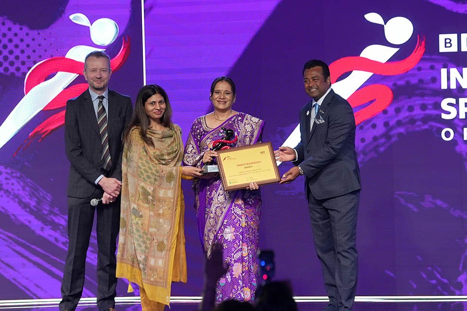Mother receiving award on behalf of winner